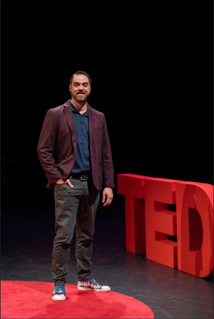 Michael Thomas standing on the TEDx stage.
